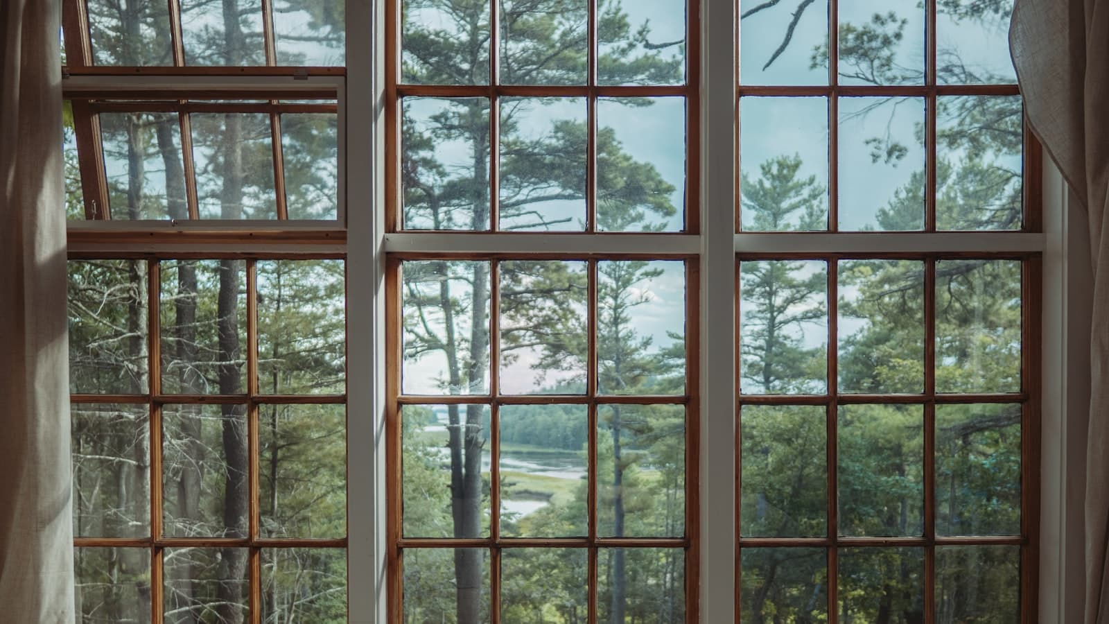 A glazier fitting a new pane of glass into a window frame