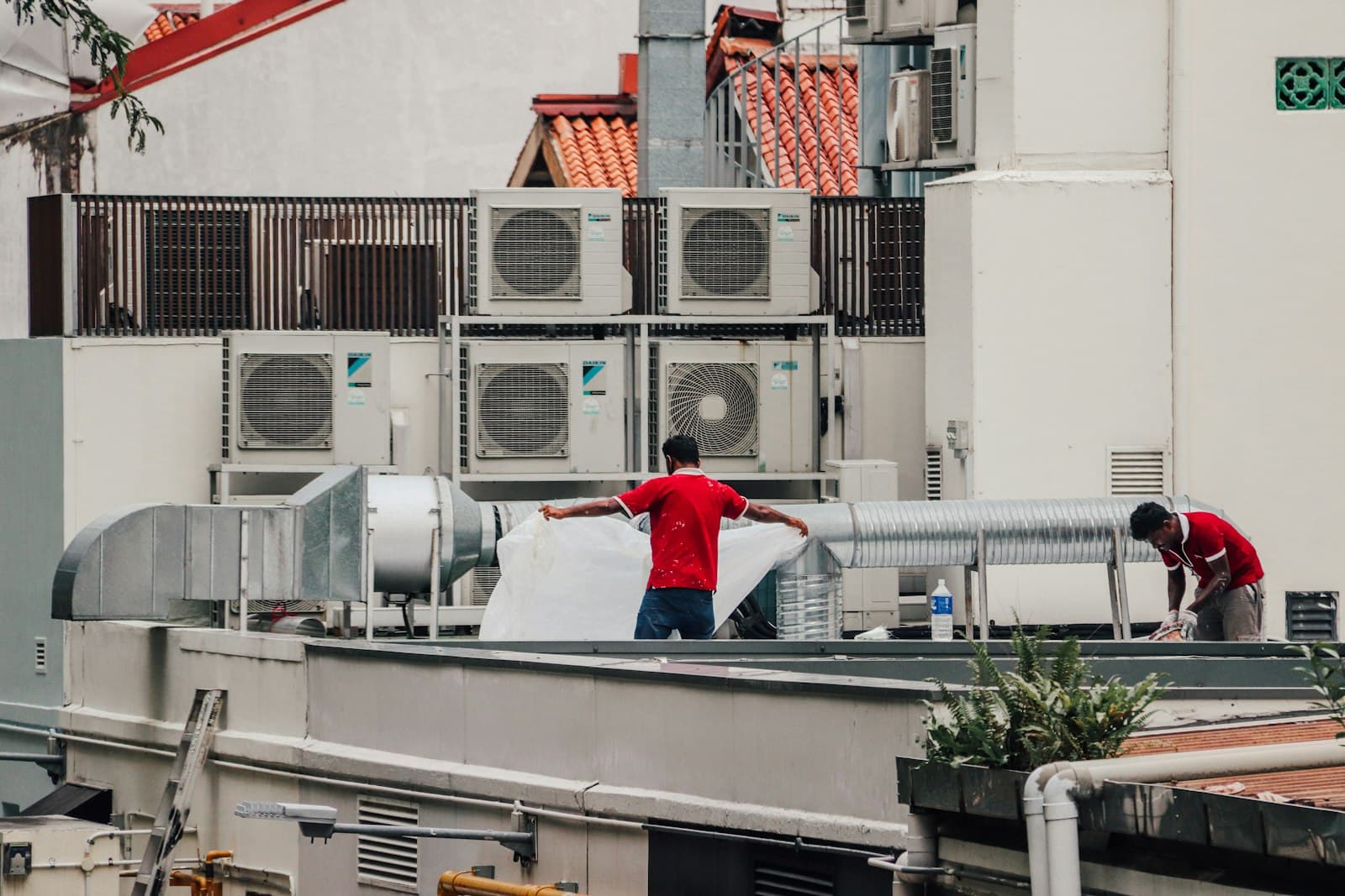A technician working on an air conditioning unit