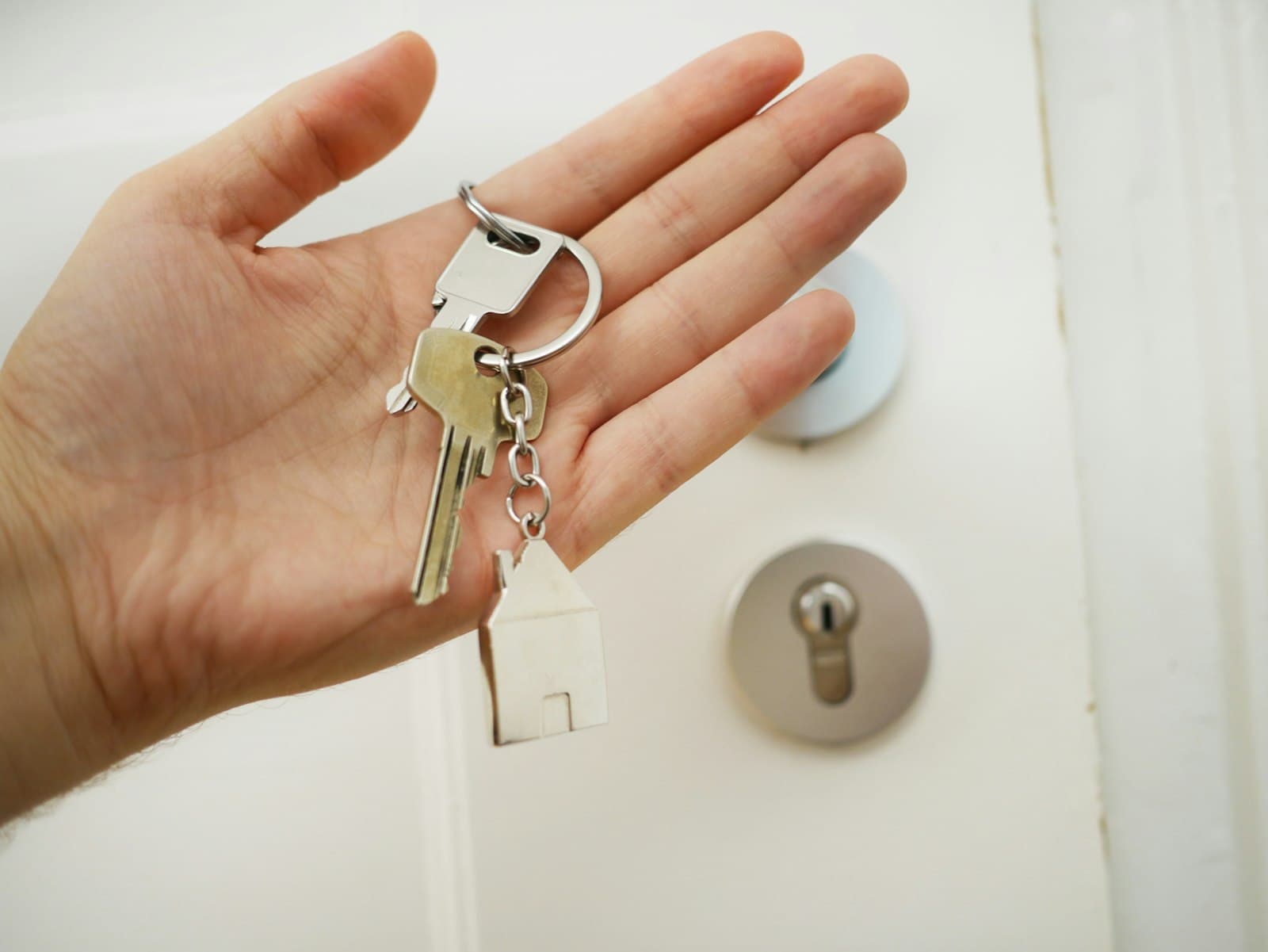 A locksmith fitting a deadlock to a front door
