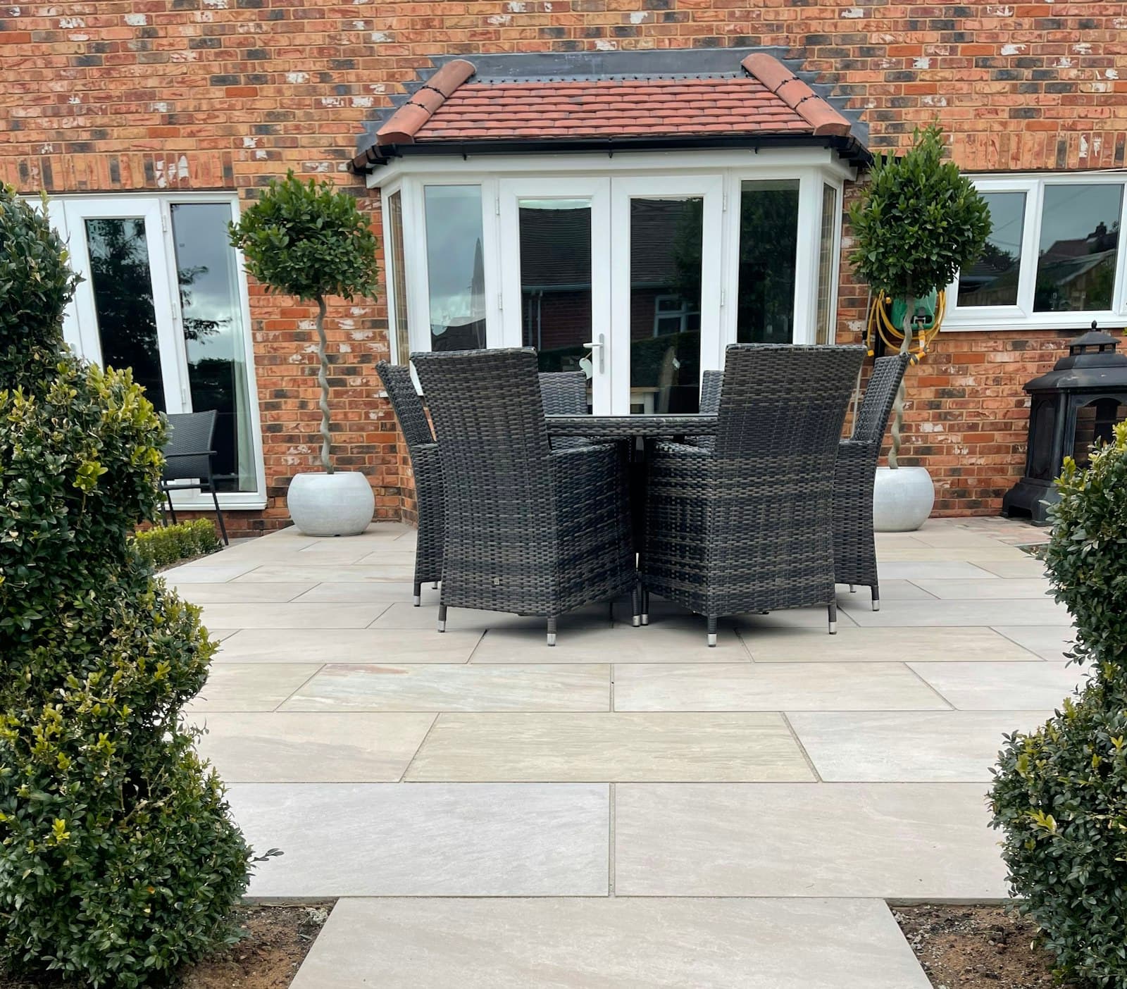 Freshly laid pavers forming a patio in a backyard
